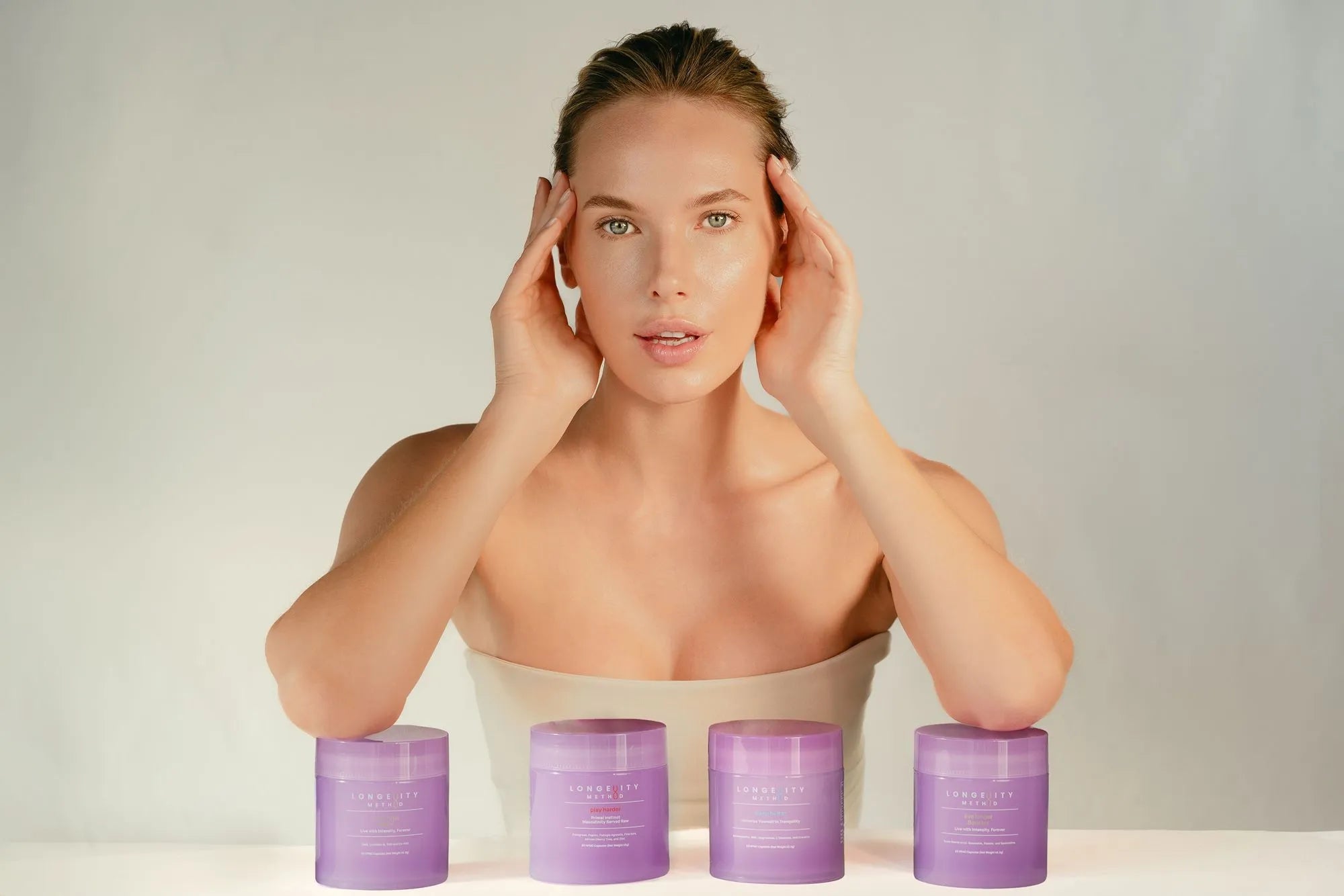 A radiant model showcasing the Longevity Method supplements collection