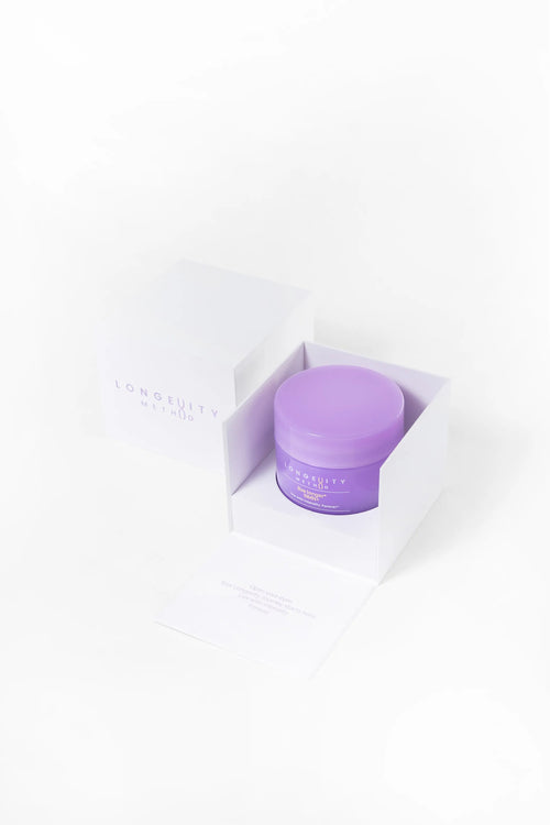 A close-up of the Longevity Method NMN+ sleek purple jar nestled in white packaging